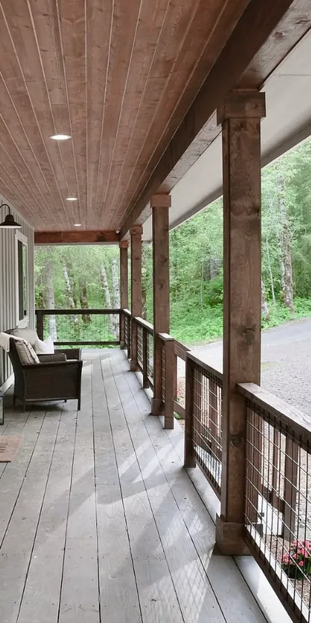 Covered porch with cedar posts, cable railing and recessed lighting