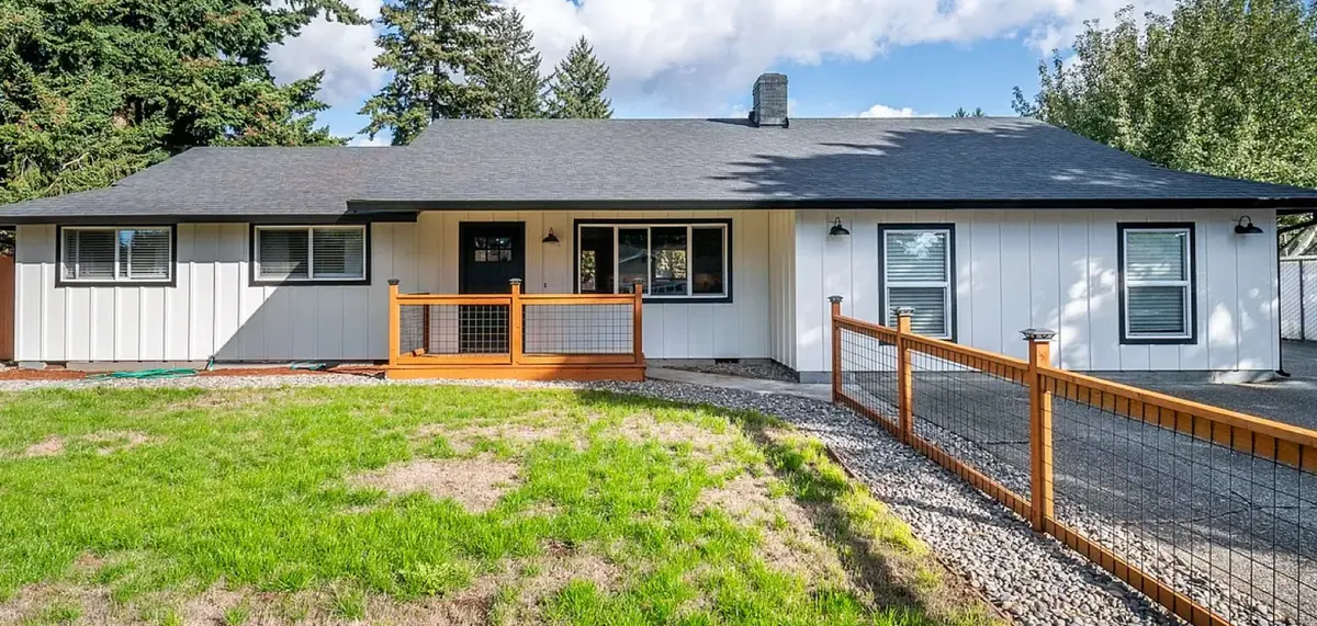 Ranch home after board-and-batten siding, new roof and a new entry porch