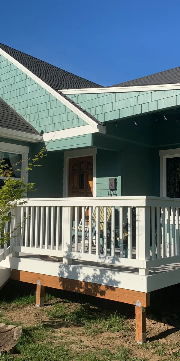 New shingle siding and white trim on a remodeled bungalow