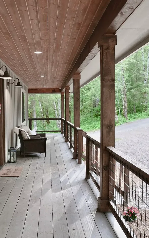 Covered porch with cedar posts, cable railing and recessed lighting