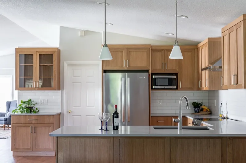Kitchen renovation with custom wood cabinetry and quartz countertops