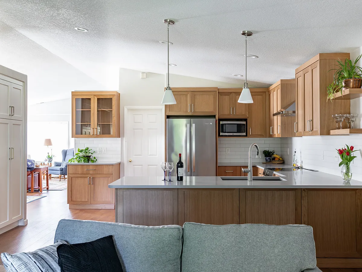 Finished kitchen remodel with wood shaker cabinets and quartz peninsula