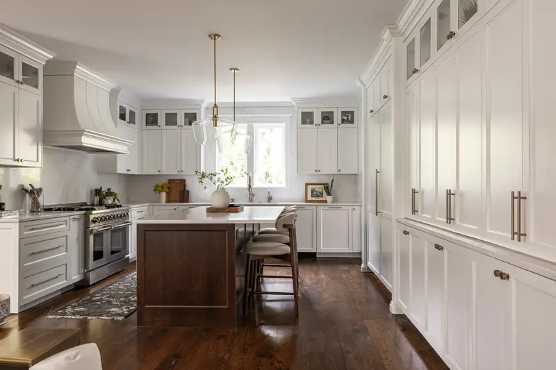 White shaker kitchen remodel with a stained wood island, brass pendant lights and floor-to-ceiling pantry cabinetry — Felida, Vancouver, WA
