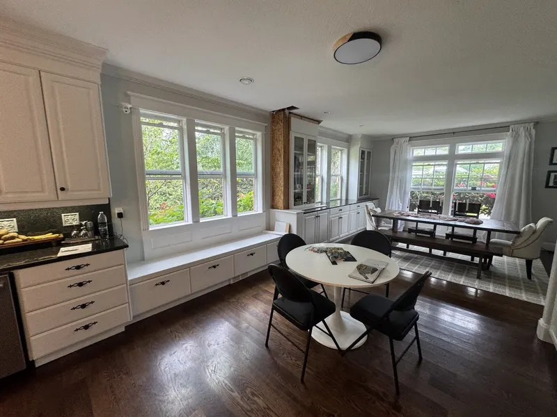 Before the remodel: the breakfast area beside the kitchen, with only a short run of cabinets by the window