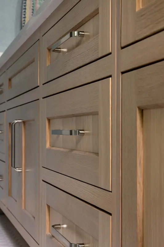 Shaker drawers on the wood vanity with brushed metal pulls
