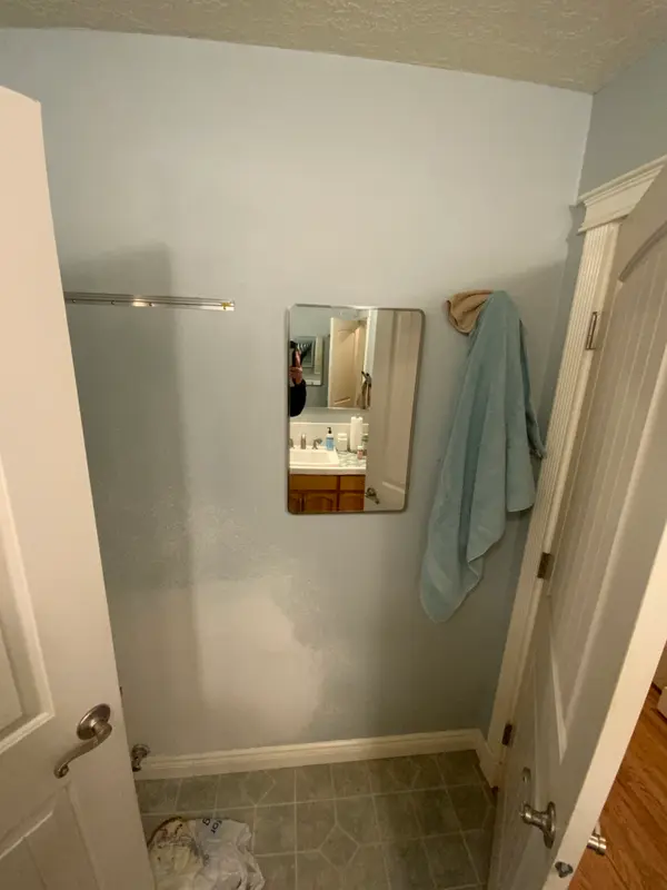 Before the remodel: the blank wall and second entrance door from the primary bedroom