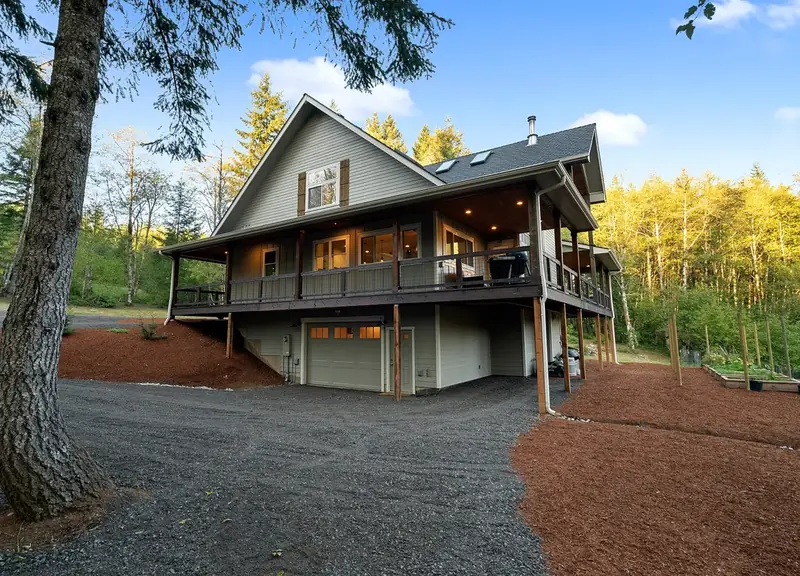 Side elevation with the daylight basement garage tucked beneath the deck — Battle Ground, WA