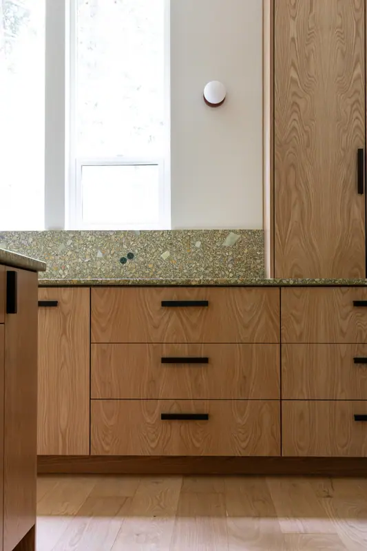 Drawer detail beneath the window, with the terrazzo-look quartz counter above white oak fronts