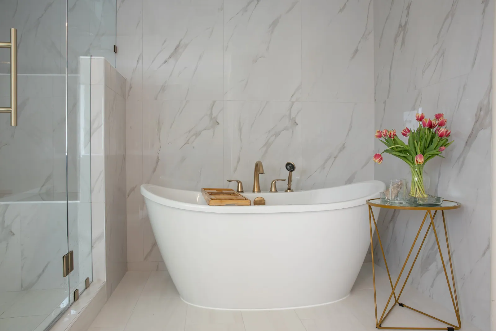 Before and after full bathroom renovation in Clark County WA — freestanding soaking tub beside a low-threshold frameless glass shower