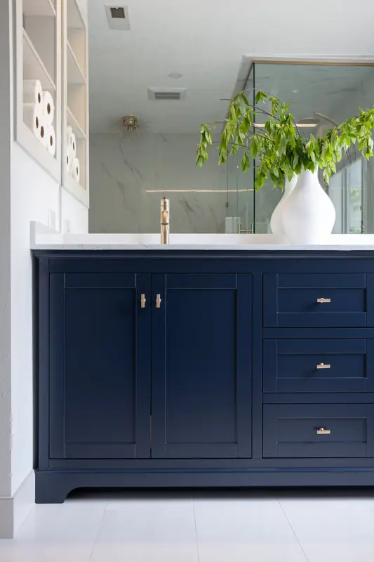 Marble-look large-format porcelain tile running full height beside the vanity