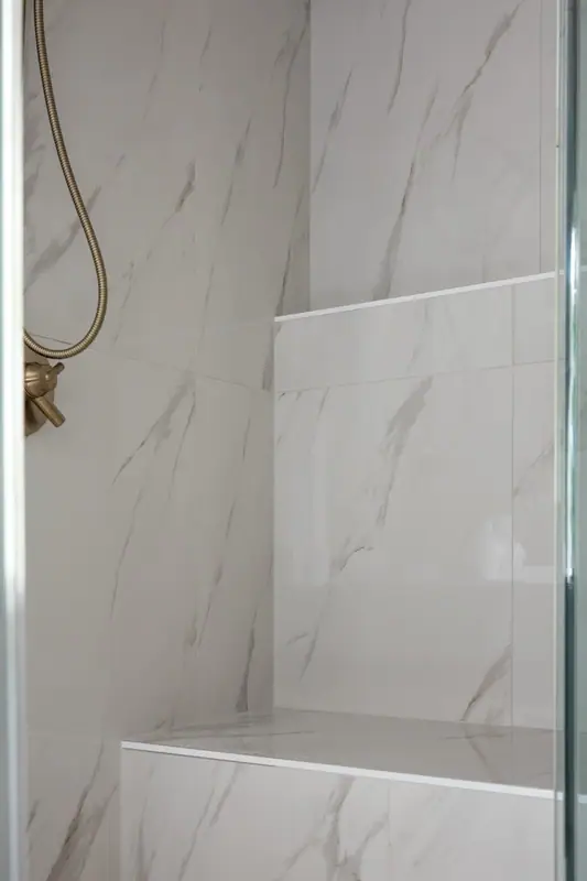 Tiled shower ceiling and full-height glass that hold steam in the enclosure
