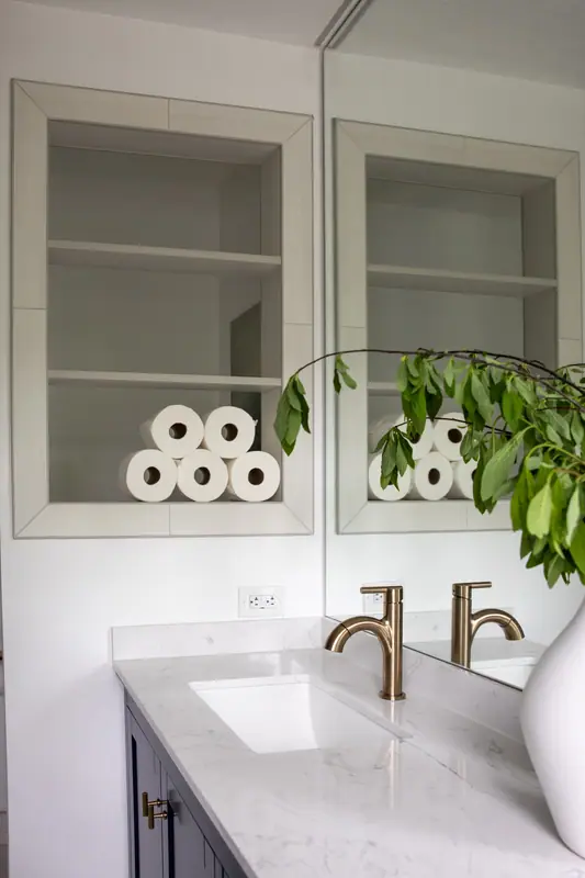 Frameless glass panel and brushed gold hinge detail