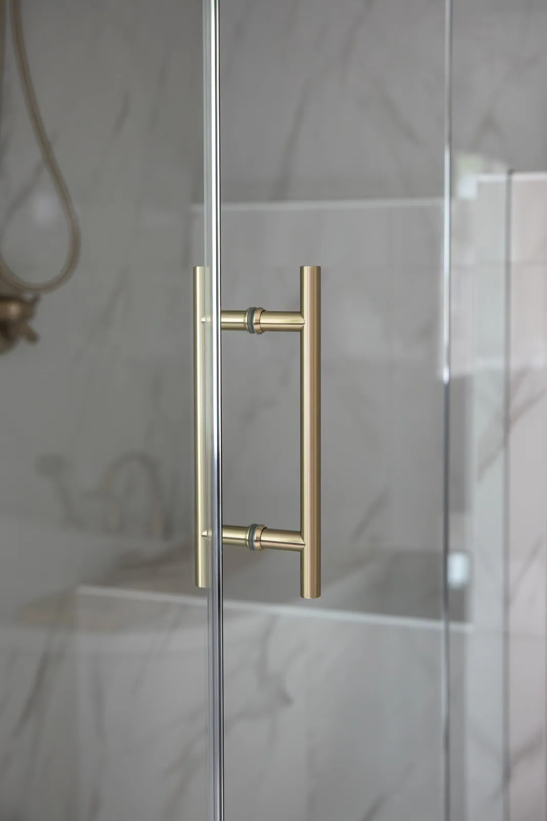 The same wall after remodeling, with a 72-inch navy shaker double vanity, quartz counter, undermount sinks and sconce lighting