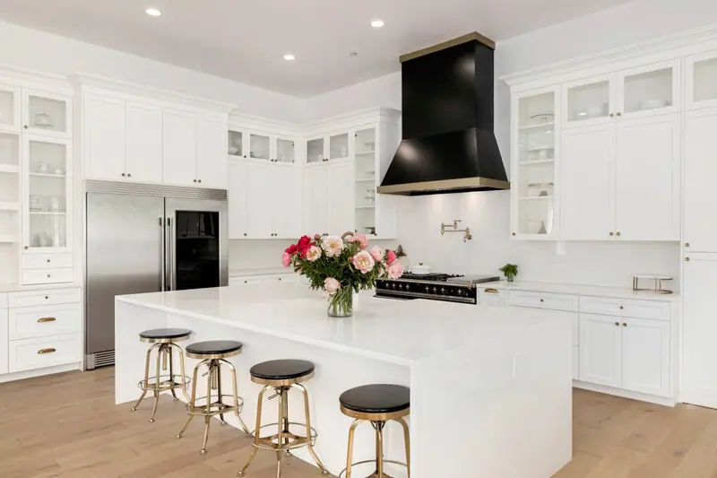 White kitchen with a black range hood and a marble-topped island — Vancouver, WA