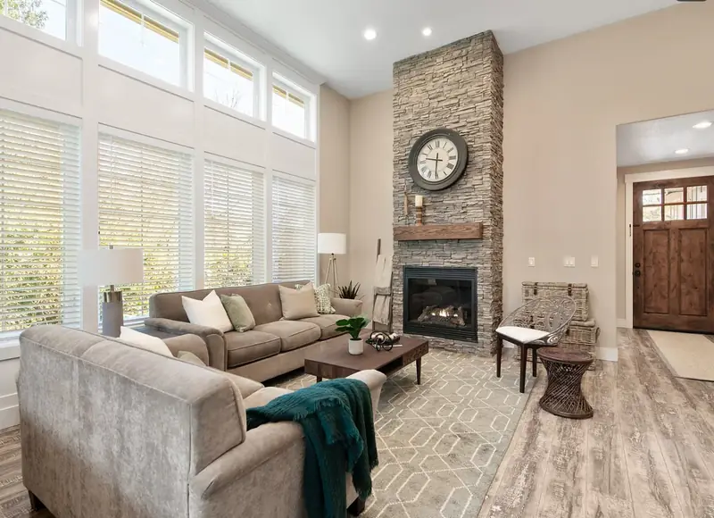 Vaulted living room with a floor-to-ceiling stacked-stone fireplace and a reclaimed wood mantel — Vancouver, WA