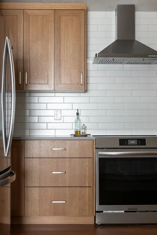 Refrigerator, drawer bank and range in the reorganized cabinet layout
