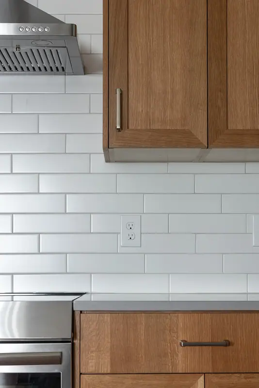 Range hood, subway tile and the counter beside the range