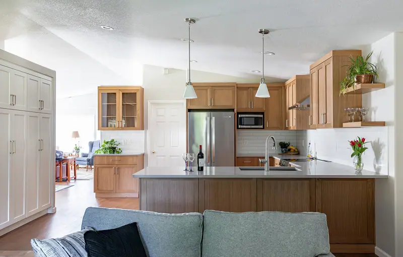 The kitchen and its lengthened peninsula seen over the living room sofa