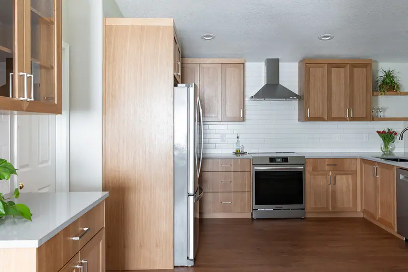 Refrigerator, hood and range viewed from the hallway entrance