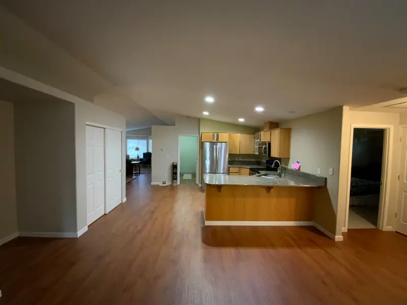 The original Felida kitchen before the remodel, with yellow-toned maple cabinets and green granite