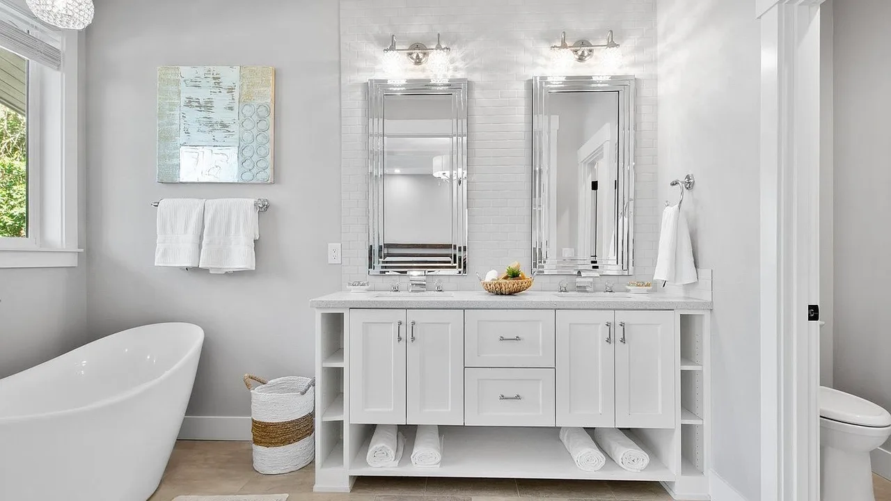 Primary bathroom remodel in Vancouver WA by Serden Group, with a white shaker double vanity, quartz counter, framed mirrors, and a freestanding soaking tub