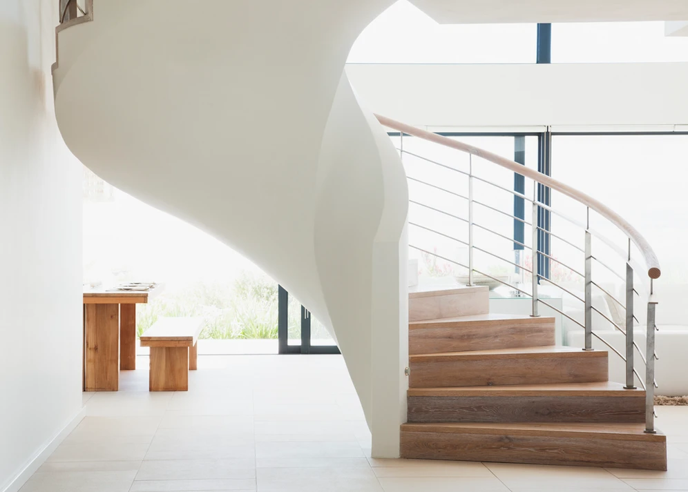 A modern home's spiral staircase, an architectural marvel, adds elegance and functionality to the interior.